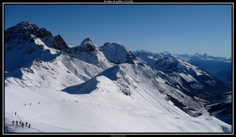 Le Grand Galibier : Le Grand Galibier puis au loin, la vallée de Serre-Chevalier. Remarquez la file ininterrompue sur l'itinéraire.