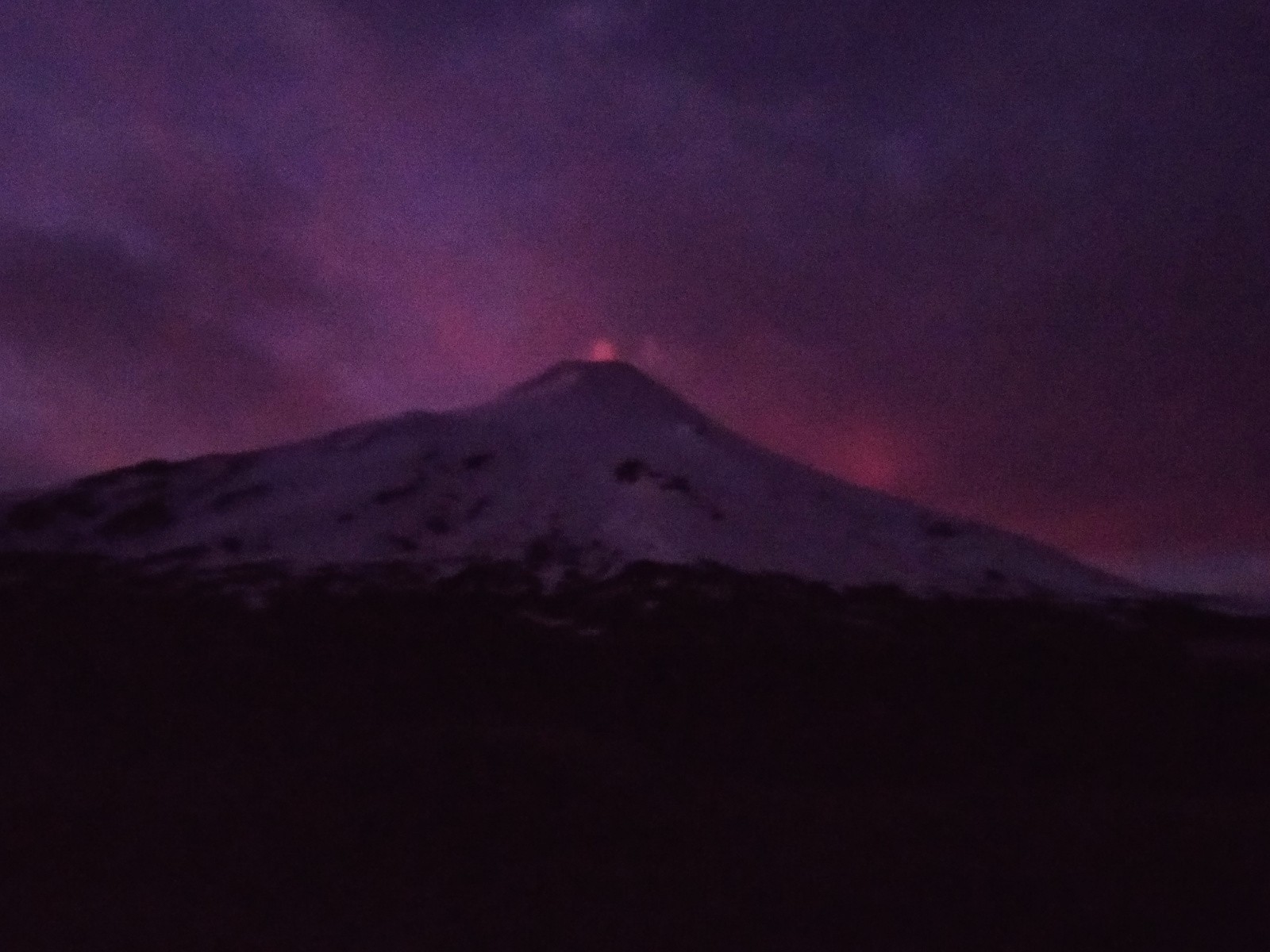 La nuit la lave se reflète dans la fumée au sommet du volcan, c'est beau (même si la qualité de cette photo ne le montre pas)/