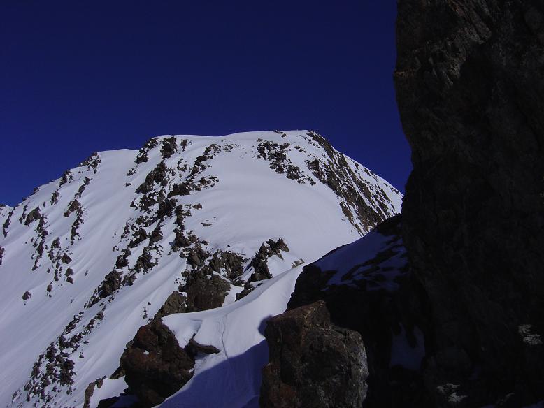Col de l'Amiante, Rocher Blanc : Le Rocher Blanc depuis le col de l'Amiante, on voit le petit passage dans les rochers et la pente à remonter pour atteindre le sommet (pente particulièrement bien enneigée)